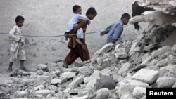 A voter deposits his ballot in the ballot box for the U.S. midterm elections at a polling place in Westminster, Colorado, Nov. 4, 2014.