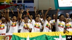 Myanmar fans cheer as they watch Kempo competition during the 27th SEA Game at Thuwunna stadium Friday, Dec.20, 2013, in Yangon, Myanmar. (AP Photo/Khin Maung Win)