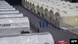 为提升新冠病毒检测能力,江苏南京在一个会展中心建立了数个临时“火眼”实验室。(2021年7月28日,法新社照片)