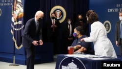 Tổng thống Joe Biden chứng kiến bà Linda Bussey được tiêm mũi vaccine COVID-19 đầu tiên trong sự kiện đánh dấu mũi chích thứ 50 triệu tại Nhà Trắng
