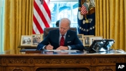 拜登总统在白宫椭圆形办公室签署一系列有关医保的行政令(2021年1月28日)