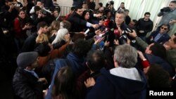 Argentine President Mauricio Macri talks to journalists after casting his vote at a polling station during mid-term primary elections in Buenos Aires, Argentina, Aug. 13, 2017.