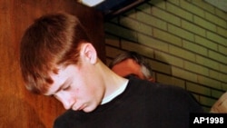 FILE - In this May 22, 1998, photo, Thurston High School student Kip Kinkel, 15, is led to his arraignment in Eugene, Ore.