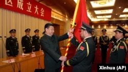 中国国家主席习近平(左前)在北京举行的中国人民解放军战区成立大会上向五大战区授予军旗。(2016年2月1日)