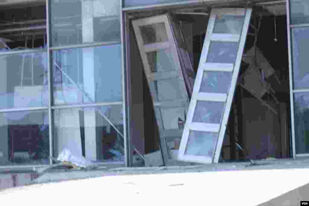 天津爆炸事故现场,核心爆炸区周围多座居民楼窗户被震碎,高速公路桥梁受损,多辆大货车被炸翻,小汽车起火或被砸,多名当地居民仍逗留在事故现场。(美国之音记者东方拍摄)