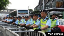 香港警察在铁马以及水马路障后面严阵以待