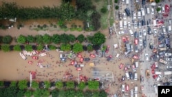 在这张2023年8月3日拍摄的航拍照片中,救援人员在河北省涿州的洪水中部署了救生筏,用于疏散居民。(美联社)