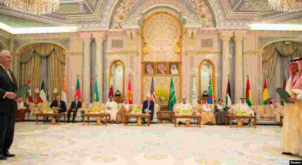 U.S. President Donald Trump (C) looks on as Secretary of State Rex Tillerson (L) and Saudi Arabia's Crown Prince Muhammad bin Nayef (R) exchange a memorandum of understanding at the Gulf Cooperation Council leaders summit in Riyadh, May 21, 2017.