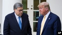 FILE - Attorney General William Barr, left, and President Donald Trump in the Rose Garden of the White House, July 11, 2019, in Washington.