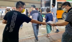 社民连主席黄浩铭7月1日下午在鹅颈桥底摆街站,向市民发特刊回顾2003年开始历年7-1游行的历史(美国之音/汤惠芸)