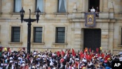 Pope Francis stands over the crowd from Cardinal's Palace where he is to give a blessing at Bolivar Square in Bogota, Colombia, Sept. 7, 2017.