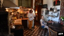 Alexandra Kulikova, right, the co-owner of a chain of apartment rentals in Saint Petersburg, talks to an AFP reporter in one of the flats for rent on June 11, 2024.