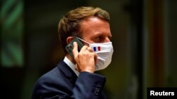 资料照片:法国总统马克龙在比利时布鲁塞尔举行的新冠疫情爆发以来首次面对面的欧盟峰会期间进行电话交谈。(2020年7月20)