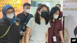 2024年9月5日,在印度尼西亚雅加达,被解雇的菲律宾市长郭华萍(中)被指控帮助建立非法在线游戏和诈骗中心并逃避菲律宾参议院的调查,由移民官员押送驱逐出境。(美联社照片)