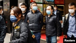 2021年12月29日被香港警方国安处拘捕的六名《立场新闻》现任和前任高层，包括代理总编辑 林绍桐（图中）被警察从办公室带走。 （路透社照片）