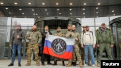 资料照片:俄罗斯瓦格纳集团在圣彼得堡的办公大楼2022年11月正式开幕期间,参观者正在合影留念。