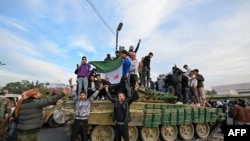 叙利亚反政府武装部队进入首都大马士革,受到群众欢迎;叙利亚军方则称阿萨德政权已结束。(法新社:2024年12月8日)