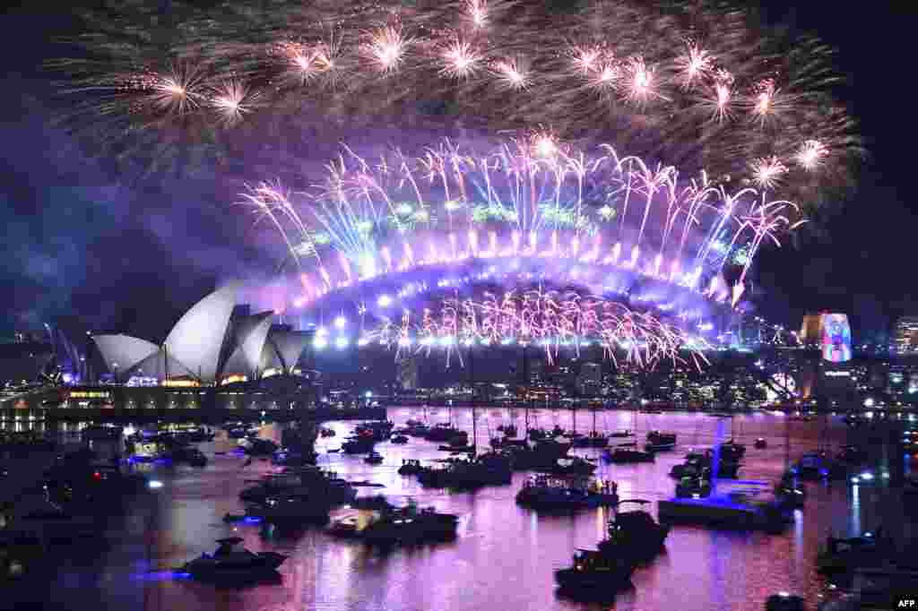 New Year's Eve fireworks erupt over Sydney's iconic Harbour Bridge and Opera House in Australia, during the fireworks show, Jan. 1, 2019.
