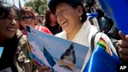 An Aymara indigenous woman holds a poster that reads in Spanish "Sea for Bolivia" during a rally in La Paz in support of Bolivia's bid for access to the Pacific Ocean, Sept. 24, 2015.