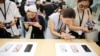 2018年9月21日,上海的苹果公司办公室对媒体展示新产品,人们体验新的Apple iPhone XS和iPhone XS Max。