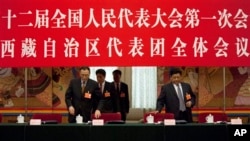 西藏自治区人大主任白玛赤林(右)和西藏自治区主席向巴平措(左)进入北京人民大会堂内人大会议西藏自治区代表团的讨论会场。