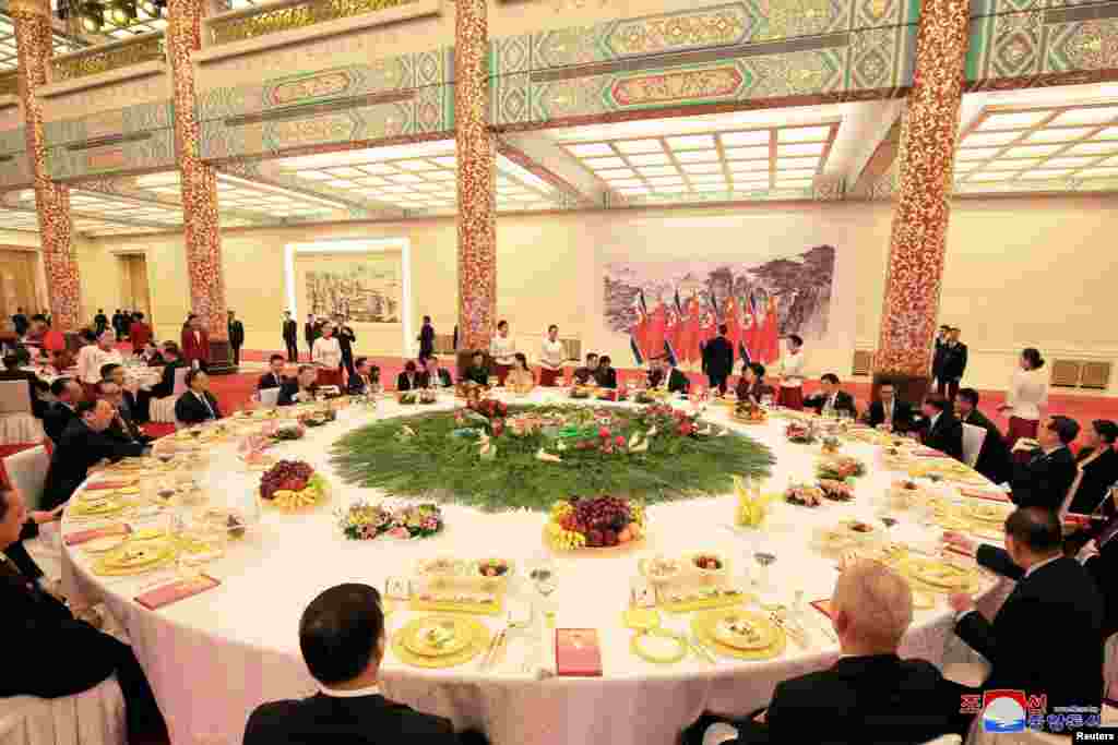 North Korean leader Kim Jong Un and wife Ri Sol Ju, and Chinese President Xi Jinping and wife Peng Liyuan attend a banquet in Beijing, China, in this undated photo released by North Korea's Korean Central News Agency (KCNA) in Pyongyang, March 28, 2018.