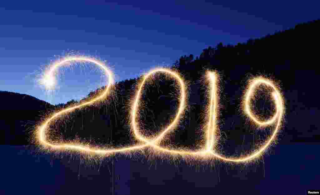 The numbers "2019" are written in the air with a sparkler near a tourist camp outside Krasnoyarsk, Russia, Dec. 31, 2018.