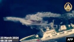 菲律宾武装部队2024年3月23日拍摄并发布的航拍视频截图显示,中国海警船(右下)使用水炮袭击菲律宾补给船。