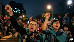 FILE - Students cheer on speakers during a gathering to mark the first anniversary of student groups stormed the parliament in Taipei, Taiwan, March 18, 2015.