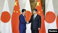 中国国家主席习近平在北京会晤到访的日本首相安倍晋三。(2018年10月26日)