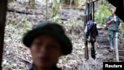 FILE - Weapons are seen at a camp of the 51st Front of the Revolutionary Armed Forces of Colombia (FARC) in Cordillera Oriental, Colombia, Aug. 16, 2016.