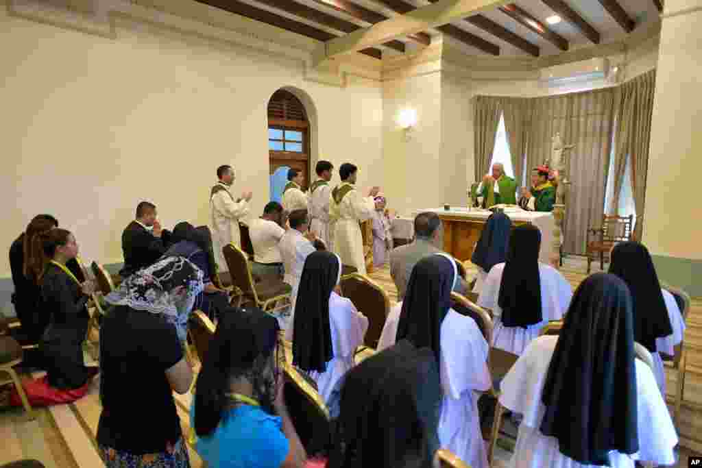 Pope Francis, background center at the altar, celebrates a Mass with Cardinal Charles Maung Bo at the archbishop's palace in Yangon, Nov. 28, 2017.