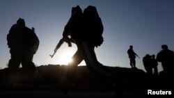 Afghan security forces arrive at the site of truck blast in Kabul, Afghanistan, Nov. 18, 2014.