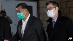 香港壹传媒创办人黎智英(左)获得保释离开香港高等法院。(2020年12月23日)