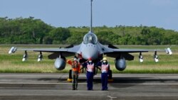 台湾空军人员在一架完成升级的F-16V战机交付仪式上敬礼。(2021年11月18日)