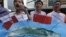 Protesters hold a model of Diaoyu islands (Senkaku islands in Japan) with Chinese national flags during a demonstration near the Japanese Consulate in Hong Kong Monday, July 9, 2012. Japan's leader said that his government is negotiating to buy the island