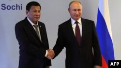 俄罗斯总统普京(右)与菲律宾总统杜特尔特在俄罗斯索契瓦尔代的俱乐部举行会谈前握手(2019年10月3日)。