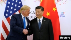 资料图:美国总统特朗普与中国国家主席习近平在2019年6月的大阪G20峰会期间会晤。