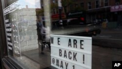 纽约布鲁克林区一个海鲜餐厅打出招牌,告诉人们5月14日恢复营业。(美联社5月11日摄)