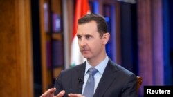 Dancers from Mathew Bourne’s “cygneture” ballet, “Swan Lake,” pose in front of Australia’s landmark Opera House and Harbor Bridge in Sydney.