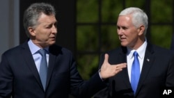 U.S. Vice President Mike Pence, right, walks with Argentina's President Mauricio Macri at the government residence in Buenos Aires, Argentina, Aug. 15, 2017.