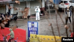 中国湖北武汉,一名身穿防护服的工人在封闭的海鲜市场里。(2020年1月10日)