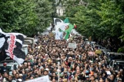 FILE - People are seen gathered for a mass anti-government protest in the center of the Algerian capital Algiers, Dec. 17, 2019.
