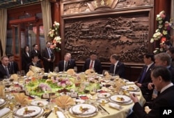 中国国家主席习近平,俄罗斯总统普京和外交部长拉夫罗夫(习近平右侧)在北京的 “一带一路”国际合作高峰论坛开幕式前的早餐会上交谈(2017年5月14日)。