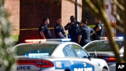 Knoxville police work the scene following a shooting at Austin-East Magnet High School in Knoxville, Tenn., April 12, 2021.