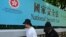 行人走过香港街头港版国安法的宣传牌。（2020年7月15日）