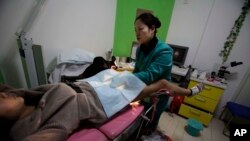 陕西省西安市的玛丽斯特普国际组织开设的堕胎诊所里,一名护士正在检查怀胎三月的孕妇南希•寅(译音)。