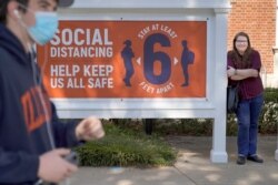 FILE - University of Illinois student Sarah Keeley, right, poses for a portrait on the college campus in Urbana, Ill., Oct. 6, 2020.
