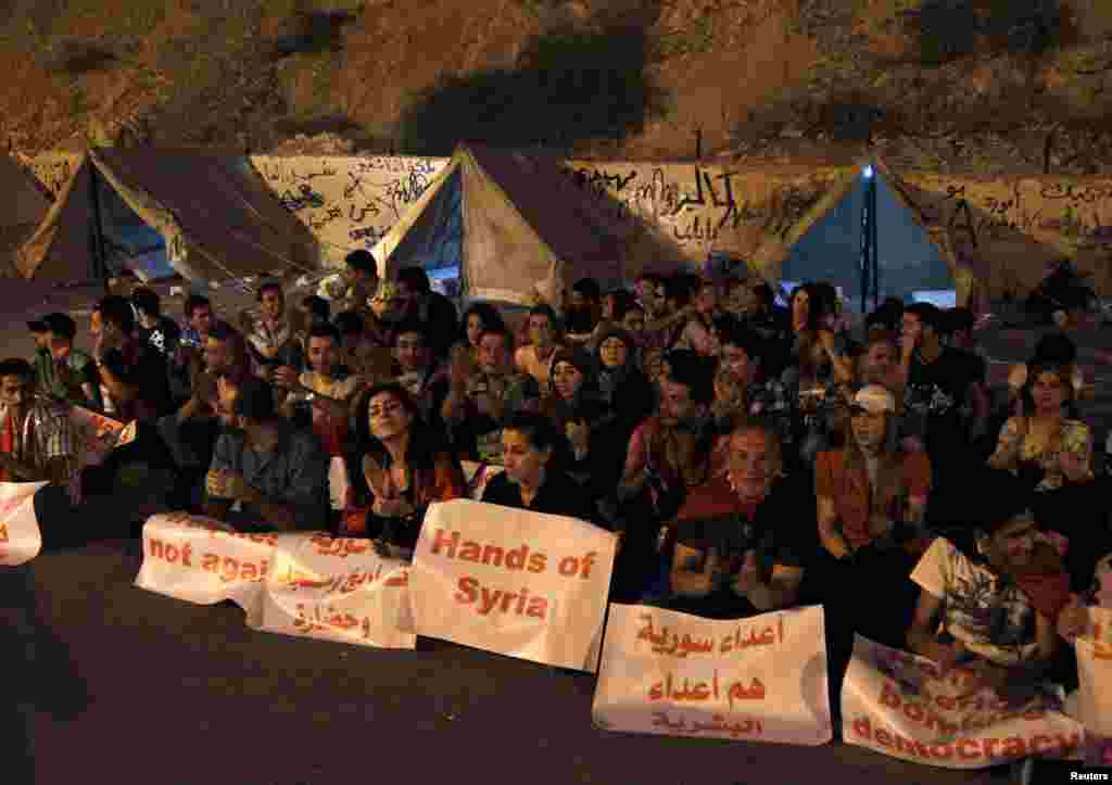 Supporters of Syria's President Bashar al-Assad take part in "Over our Bodies", a campaign to organize human shields against possible U.S. strikes, at Qasion Mountain overlooking the capital Damascus, Sept. 2, 2013.