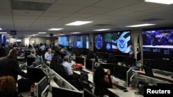 FILE - U.S. Department of Homeland Security election security workers monitor screens in the DHS National Cybersecurity and Communications Integration Center (NCCIC) in Arlington, Virginia, U.S. November 6, 2018.